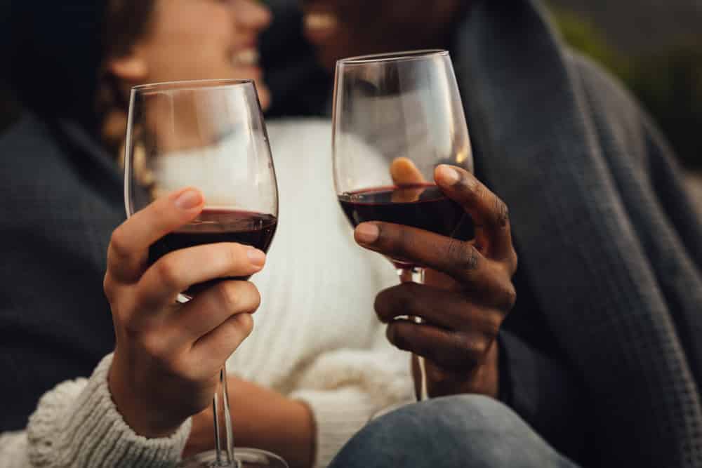 A couple enjoying a glass of wine during one of the most romantic getaways in Upstate New York