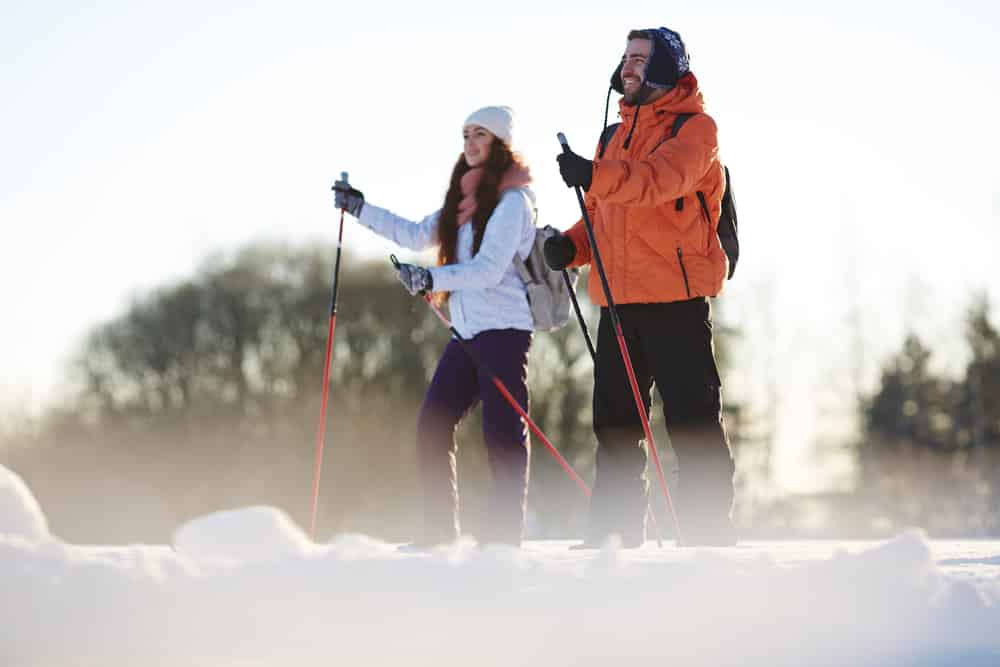 A couple enjoying some snow shoeing while staying at our Upstate New York hotel in the winter