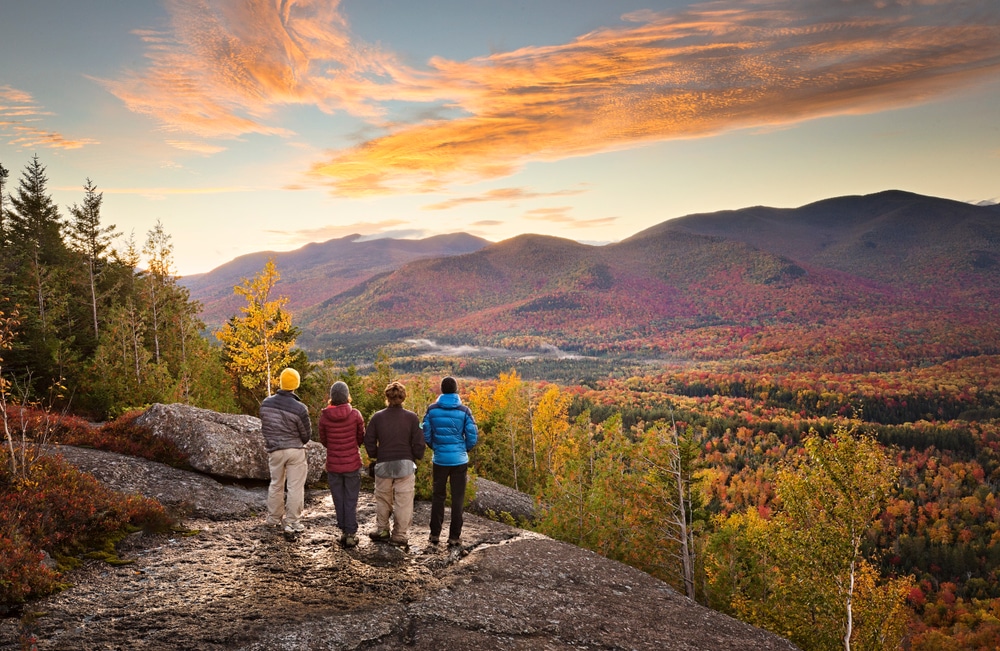 Hikers enjoying the view in fall from the best hikes in the Adirondacks