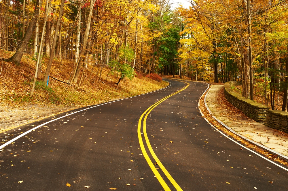 Enjoy beautiful fall roads like this during your romantic getaways in the Adirondacks