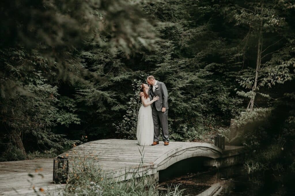 Elopement Packages in Upstate NY, photo of newlyweds on a pretty bridge in the adirondacks