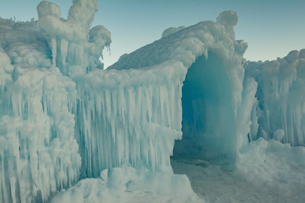 One of the best things to do in Upstate NY is visit the Ice Castles Lake George, couple skating on an ice rink