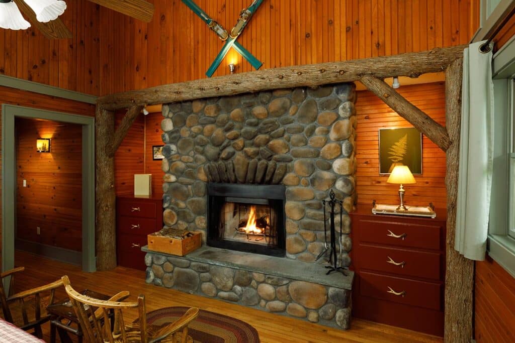 Mirror Lake room fire place at Friends Lake inn, one of the top hotels near Gore Mountain Ski Resort.
