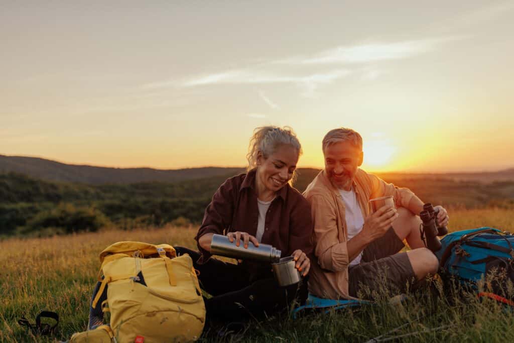 Couple takes a break from hiking for a hot beverage during their weekend getaways from NYC.